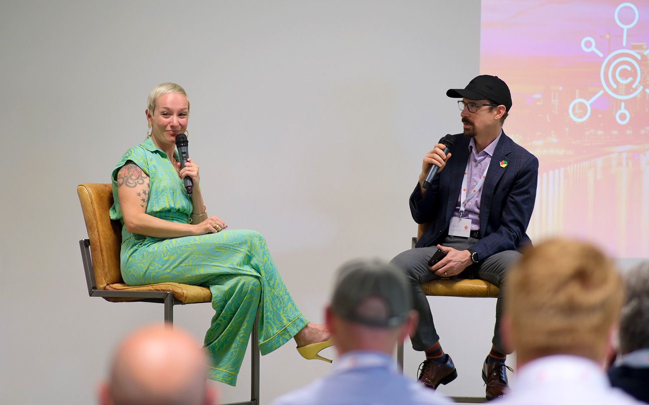 A person and person sitting in chairs with microphones

AI-generated content may be incorrect.