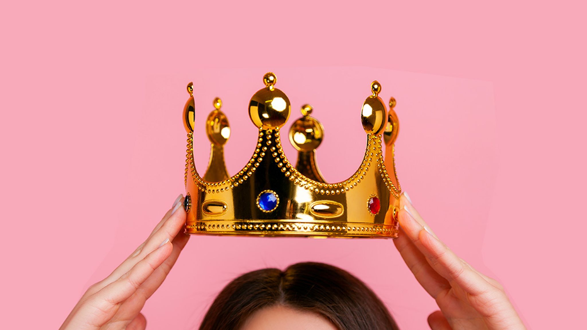 A crown going on a woman's head