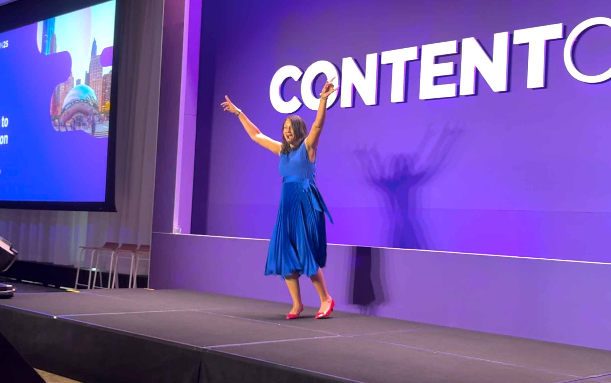A person on a stage with her arms up

AI-generated content may be incorrect.