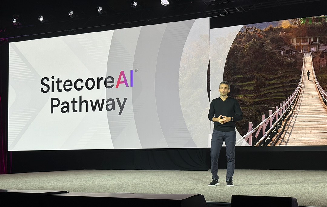 A person standing on a stage

AI-generated content may be incorrect.