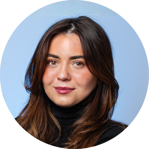 A person with brown hair and a black turtleneck

AI-generated content may be incorrect.