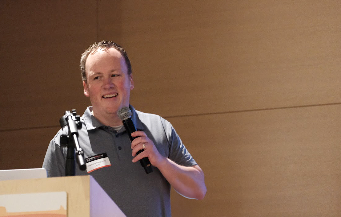 A person speaking into a microphone
AI-generated content may be incorrect.