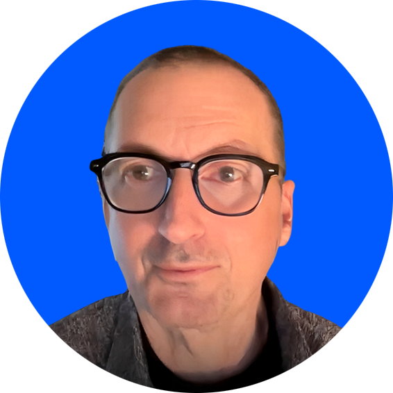 A person wearing glasses and a grey jacket
AI-generated content may be incorrect.